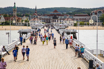 Sopot, Poland - Juny, 2019: The Sopot Pier in the city of Sopot built in 1827. At 511m, the pier is the longest wooden pier in Europe in Sopot, Poland. - obrazy, fototapety, plakaty