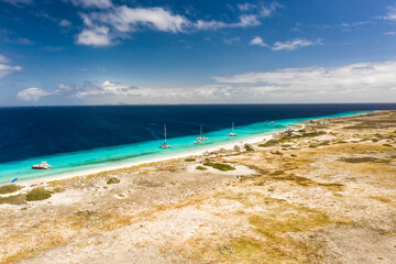 Fototapeta na wymiar Aerial view of coast of Klein Curacao in the Caribbean Sea with turquoise water, cliff, beach and beautiful coral reef