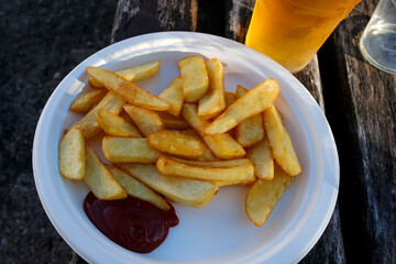 street food: french fries with ketchup and beer