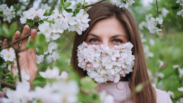 Young girl with blue eyes in the flower mask