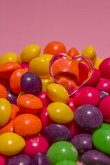 a pile of colorful Skills sweets with a pink heart on top