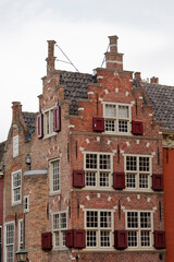 Fototapeta premium Dutch traditional rich medieval brick architecture with bright exterior facades and window as known from many a painting