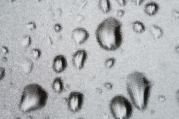 Drops of water on the glass. Wet glass. Background image. A closeup.