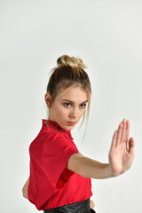 beautiful girl in red doing kung fu training poses