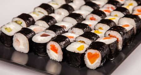Hoso sushi set and rolls for sushi heart symbol. Various sushi and rolls with fish cheese heart shape. Isolated over white background. Japanese kitchen.