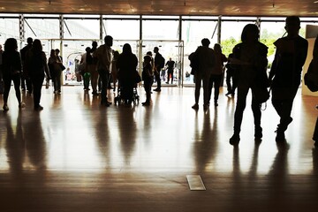 Crowd silhouettes at main entrance of convention center.Turin Italy May 10 2019