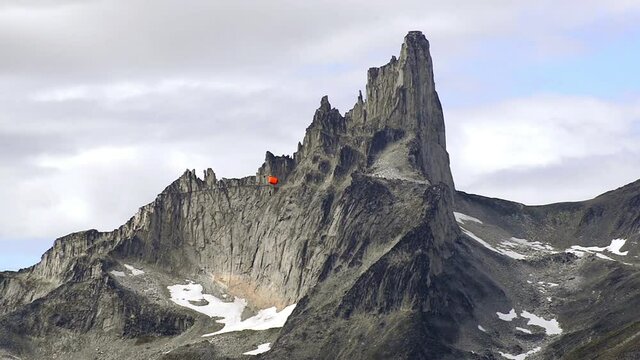 WS TS Base jumper with paraglide after jumping from Ulamertorsuaq near Tasermiut Fjord / South Greenland, Greenland