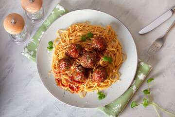 Spaghetti pasta with meatballs and tomato sauce. View from above, top view