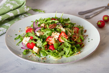 Feta cheese strawberry cucumber rocket (arugula) salad with pecan nuts - healthy vegetarian food