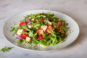 Feta cheese strawberry cucumber rocket (arugula) salad with pecan nuts - healthy vegetarian food