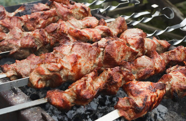 Marinated meat, mounted on a skewer, grilled on charcoal. Grilled pork skewers