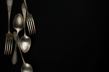 fork and spoon on black background