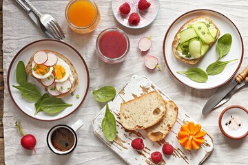 Breakfast table with sandwiches, smoothie, citrus juice and fresh raspberry. Flat layot