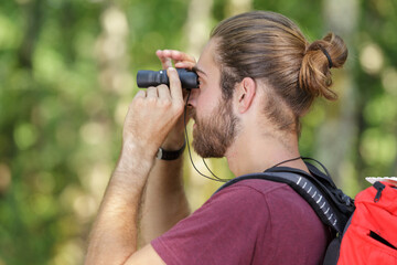 man with binoculars in nature