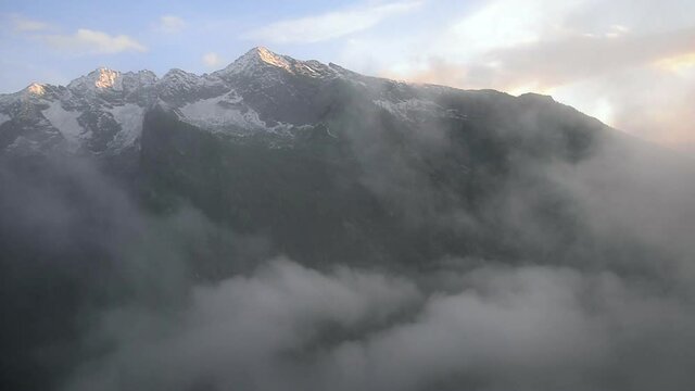 WS PAN Foggy valley and snowcapped mountain range / Val Di Mello, Sondrio, Italy