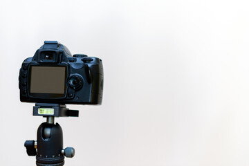 Camera on a tripod.White studio background.Copy space.waiting for a blogger.