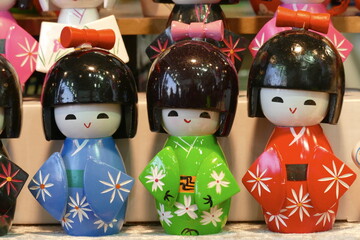 Japanese wooden kokeshi dolls in Kimono suit, which are a toy for girls and boys, or even for a...