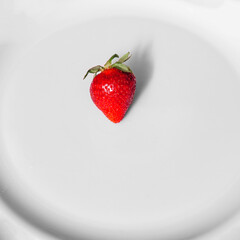 Ripe red strawberrie in a white background. View from above.