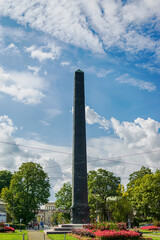 Vertical view of Caroline’s Plaza with its black obelisk in the center. Photograph taken in Munich, Bavaria, Germany.