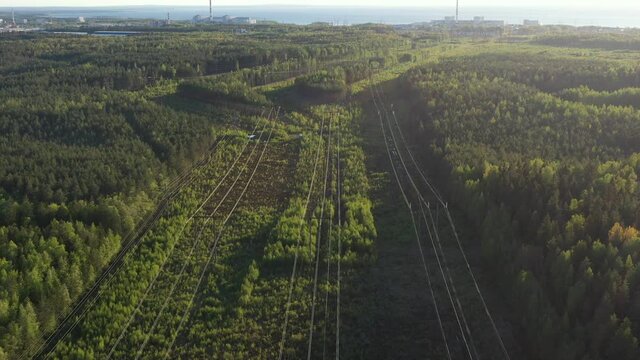 Nuclear power plant towers and powerlines in forest. Aerial view from drone