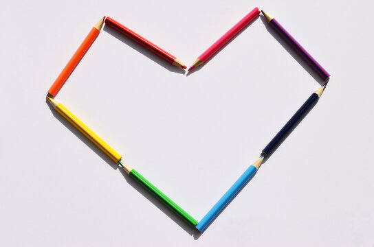 heart of colored pencils on a white background close-up