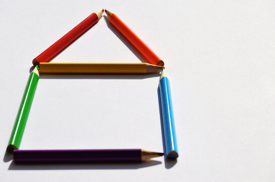 house of colored pencils on a white background close-up