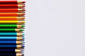 Colored pencils for the school are lined up on the left side of the top with a copy space
