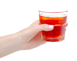 Glass of red compote juice in hand on white background isolation