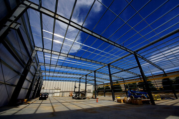 Naklejka premium steel beams make the frame of an industrial building under construction