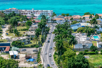 Montego Bay, Jamaica. Aerial/ drone view near coastline in tourism resort city. Turquoise ocean water along the coast of tropical Caribbean island.