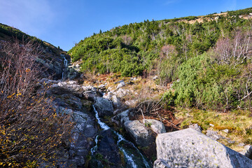 Waterfall among the rocks in the valley of the Giant Mountains in Poland.