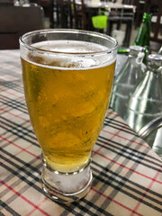 a glass of beer on the table in the restaurant