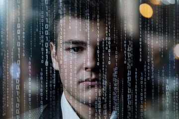 Face of a young businessman on a background of binary codes.