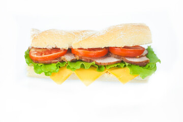 Big tasty sandwich with tomato lettuce with soap and ham on a white plate