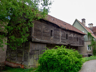 Historical log building with red tiles roof in Kuldiga, Latvia