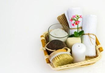 Eco set for spa treatments at home with towels, pumice, salt, candle on a white background.