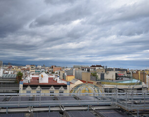 Storm about to fall over the city of Barcelona, ​​gray and cloudy sky, popular houses