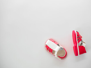 Top view of pair of white red sandals with clasps fasteners at white background with place for text