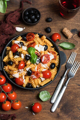 Pasta fusilli with cherry tomatoes, basil and olives. Homemade pasta 