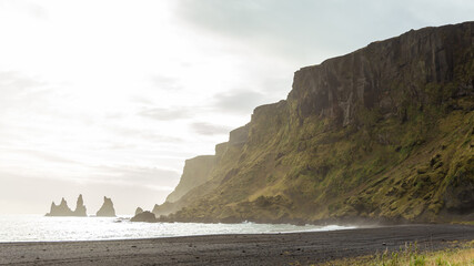 Black Sand beach and dramatic cliff sides in Iceland Landscape during Travels and Arctic Adventures