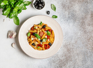 Pasta fusilli with cherry tomatoes, basil and olives. Homemade pasta 