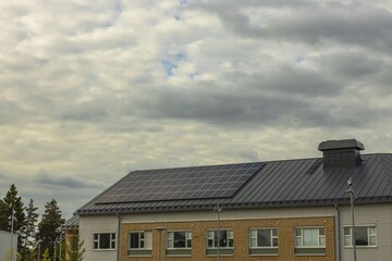View of building roof equipped with solar panels. Modern technology concept. 