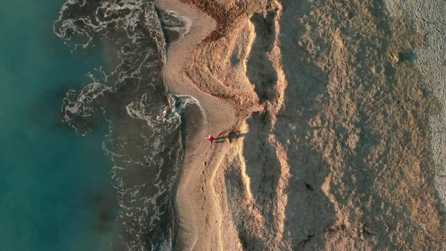 WS SLO MO TS POV HA Man walking on beach / Rosignano, Livorno, Italy