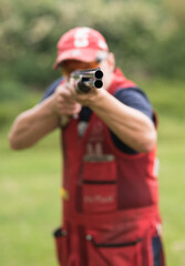 Man shooting skeet with a shotgun. Skeet shooting, trap shooting.