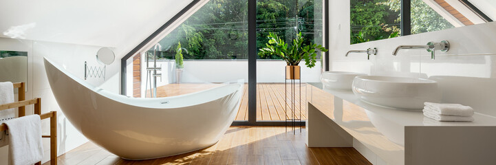 Luxury attic bathroom with bathtub, panorama - obrazy, fototapety, plakaty
