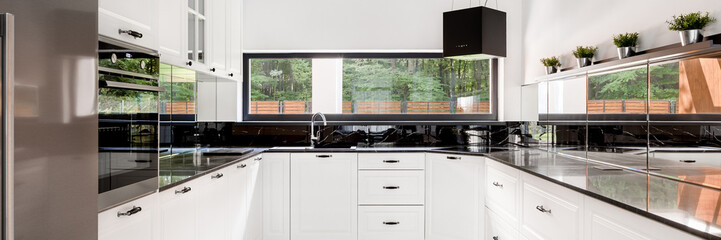 Panorama of black and white kitchen
