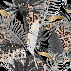 Seamless leopard skin pattern with tropical leaves. Vector. © Yumeee