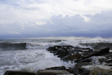 Sea, waves are breaking on stones, seashore