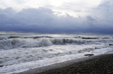 Storm, strong waves, sea coast, pebbles on the beach
