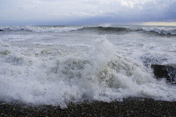 Storm, strong waves, sea coast, pebbles on the beach